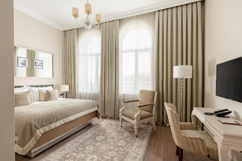 Boutique 19 bedroom with arched windows and soft neutral decor