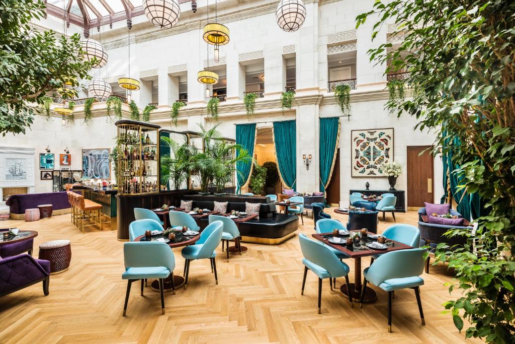 The Merchant Baku atrium lounge with skylight and tropical greenery